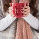 woman-in-winter-clothes-holding-a-hot-drink-400×242
