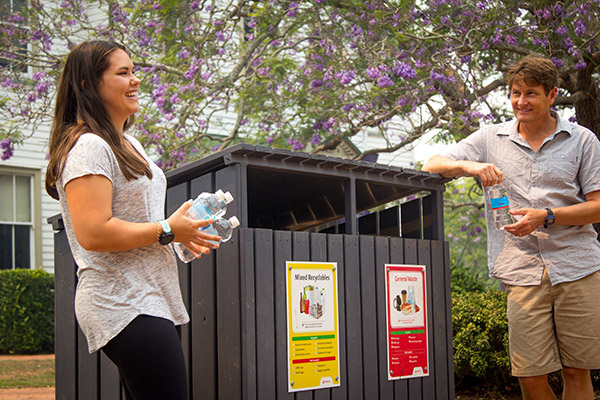 Zoey-Elise Watson and Dr Jason Morton with the new dual 240-litre general waste and commingled recycling bins