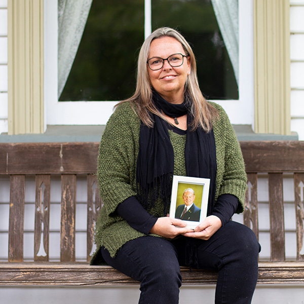 Stephanie Barber holds framed photograph of her father