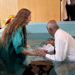 Avondale University students helps with baptism in font