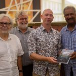 Peter Williams presents book to Gilbert Cangy