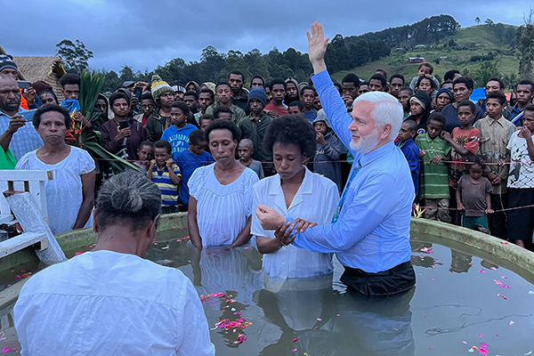 Neil Thompson baptises a woman in Papua New Guinea