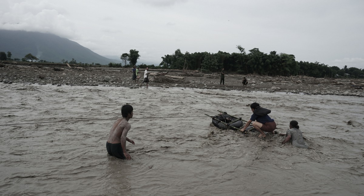 ADRA Myanmar staff members cross river
